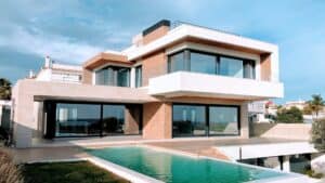 Brown house with pool under blue sky